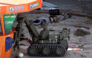Illustration for article titled Photos of Robot Cleaning Up After Suicide Bomber: Reality Checks Are Often Disturbing